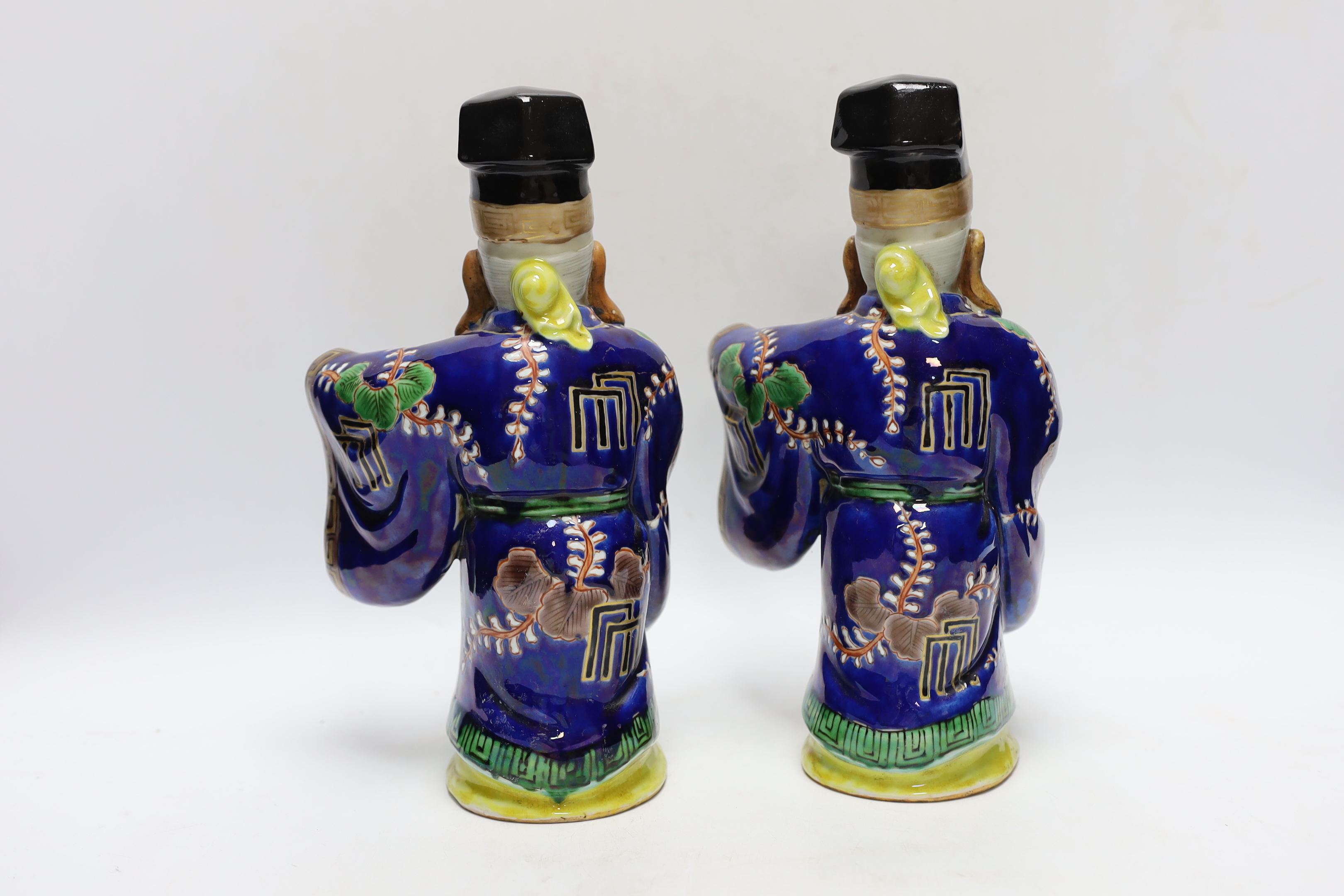 Two early 20th century Japanese enamelled porcelain figures of immortals, 27.5cm high
